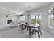Open-concept living and dining areas with fireplace, couch, and dining set at 9986 Gallop Ln, Fishers, IN 46040
