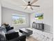 Bright living room with comfortable seating, ceiling fan, large window, and stylish decor at 9986 Gallop Ln, Fishers, IN 46040