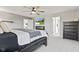 Spacious main bedroom with stylish decor, a dark bed frame, and natural light at 9986 Gallop Ln, Fishers, IN 46040