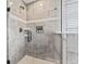 Modern tile shower with glass door, shower head, and built-in niche for toiletries at 9986 Gallop Ln, Fishers, IN 46040