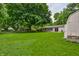 Expansive backyard with mature trees, hammock, and brick patio at 10155 Orchard Park W Dr, Carmel, IN 46280