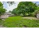 Spacious backyard featuring brick patio, shed, and mature trees at 10155 Orchard Park W Dr, Carmel, IN 46280