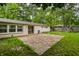 Brick backyard patio with view of the house and lush green space at 10155 Orchard Park W Dr, Carmel, IN 46280