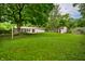 Large backyard featuring mature trees, shed, and hammock at 10155 Orchard Park W Dr, Carmel, IN 46280