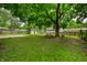 Large backyard with picnic table, storage shed, and mature trees at 10155 Orchard Park W Dr, Carmel, IN 46280