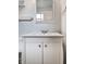 Close up on bright bathroom vanity with white cabinets and drawers at 10155 Orchard Park W Dr, Carmel, IN 46280