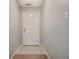 Clean entryway with light blue walls and tiled floor, showcasing a bright white front door at 10155 Orchard Park W Dr, Carmel, IN 46280