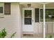 Close-up of a white front door, brown shutters, and a welcoming welcome mat at 10155 Orchard Park W Dr, Carmel, IN 46280