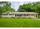 Charming single-story home with attached garage, well-maintained lawn, and colorful flowerbeds enhancing curb appeal at 10155 Orchard Park W Dr, Carmel, IN 46280