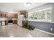 Eat-in kitchen space with white appliances, oak cabinets, and a large window at 10155 Orchard Park W Dr, Carmel, IN 46280