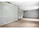 Spacious living room with neutral walls, carpet, and bright window lighting at 10155 Orchard Park W Dr, Carmel, IN 46280