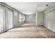 Bright, carpeted living room featuring large windows with blinds allowing ample natural light at 10155 Orchard Park W Dr, Carmel, IN 46280