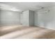 Open living area featuring neutral paint, carpet, and a doorway leading to another room at 10155 Orchard Park W Dr, Carmel, IN 46280
