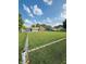 Expansive backyard featuring a chain-link fence, lush green lawn, and single story brick home at 1050 Laguna Ln, Greenwood, IN 46143