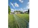 Expansive backyard featuring a chain-link fence, lush green lawn, and single story brick home at 1050 Laguna Ln, Greenwood, IN 46143