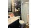 Bathroom featuring a modern vanity, open shelving, and glass door shower at 1050 Laguna Ln, Greenwood, IN 46143
