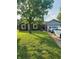 Charming brick ranch-style home featuring a lush green lawn and mature trees, offering great curb appeal at 1050 Laguna Ln, Greenwood, IN 46143