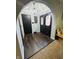 Inviting foyer with stylish wood flooring, decorative lighting, and a beautifully designed arched doorway at 1050 Laguna Ln, Greenwood, IN 46143