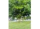 A large tree is showcased in the front yard at 1050 Laguna Ln, Greenwood, IN 46143