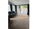 Bright living room with carpet, large windows, and backyard views at 1050 Laguna Ln, Greenwood, IN 46143