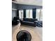 Cozy living room featuring comfortable seating, large windows, and pool views at 1050 Laguna Ln, Greenwood, IN 46143