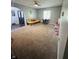 Spacious living room featuring plush carpeting, neutral paint, and large windows providing plenty of natural light at 1050 Laguna Ln, Greenwood, IN 46143