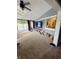 Bright living room featuring sliding glass door, grey brick accent wall and neutral carpet at 1050 Laguna Ln, Greenwood, IN 46143