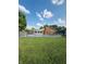 A fenced-in swimming pool with a brick house in the background surrounded by a green lawn at 1050 Laguna Ln, Greenwood, IN 46143