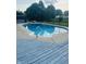 Backyard pool with a blue wood deck overlooking a yard and fence at 1050 Laguna Ln, Greenwood, IN 46143