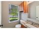 Bathroom with granite counters, wood cabinets, and window providing natural light at 1246 Valdosta Pl, Westfield, IN 46074