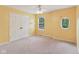 Bright yellow bedroom with carpet, closet, ceiling fan, and unique oval window at 1246 Valdosta Pl, Westfield, IN 46074
