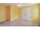 Bright yellow bedroom with carpet, closet, and ceiling fan at 1246 Valdosta Pl, Westfield, IN 46074