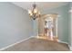 Open dining room with carpet floors, a hanging chandelier, and arched doorway leading to the kitchen at 1246 Valdosta Pl, Westfield, IN 46074