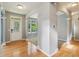 Bright foyer with hardwood floors, arched doorways, and a view to the front door and living area at 1246 Valdosta Pl, Westfield, IN 46074