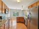 Open kitchen featuring granite countertops, stainless steel appliances, hardwood flooring, and wood cabinets at 1246 Valdosta Pl, Westfield, IN 46074