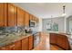 Kitchen featuring granite countertops, tile backsplash, stainless appliances, and hardwood flooring at 1246 Valdosta Pl, Westfield, IN 46074