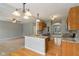 Open kitchen with granite countertops, stainless steel appliances, and hardwood flooring throughout at 1246 Valdosta Pl, Westfield, IN 46074