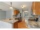 Open kitchen with granite countertops, stainless steel appliances, and hardwood flooring throughout at 1246 Valdosta Pl, Westfield, IN 46074
