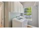Bright laundry room featuring a washer and dryer with white cabinets at 1246 Valdosta Pl, Westfield, IN 46074