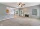Open-concept living room with fireplace, view into the kitchen, and access to the backyard at 1246 Valdosta Pl, Westfield, IN 46074