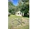View of the backyard with a garden and two sheds at 130 S Arlington Ave, Indianapolis, IN 46219