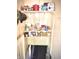 Shelves above basement access stairs are stocked with food and supplies at 130 S Arlington Ave, Indianapolis, IN 46219