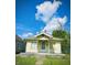 Charming bungalow featuring a front porch and a well-maintained lawn under a bright, cloudy sky at 130 S Arlington Ave, Indianapolis, IN 46219