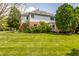 Backyard view showing a two-story home with a well-maintained lawn and mature landscaping at 14030 Old Mill Ct, Carmel, IN 46032