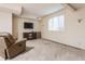 Basement Gathering room featuring a recliner, TV, and storage shelves at 14030 Old Mill Ct, Carmel, IN 46032