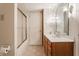 Bathroom with wood vanity, sliding shower doors, and bright lighting at 14030 Old Mill Ct, Carmel, IN 46032