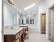 A full bathroom with a dual sink vanity, large mirrors, soaking tub, and walk-in shower at 14030 Old Mill Ct, Carmel, IN 46032