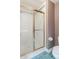 A shower with glass doors, unique wallpaper, and updated fixtures create a functional full bathroom at 14030 Old Mill Ct, Carmel, IN 46032