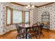 Dining area with wood table set in front of a bright bay window at 14030 Old Mill Ct, Carmel, IN 46032