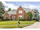 Charming brick home with manicured lawn, a welcoming entrance, and beautiful trees at 14030 Old Mill Ct, Carmel, IN 46032